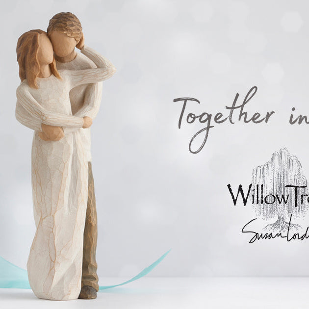 Willow Tree figurines by Susan Lordi displayed on wooden shelf with natural light