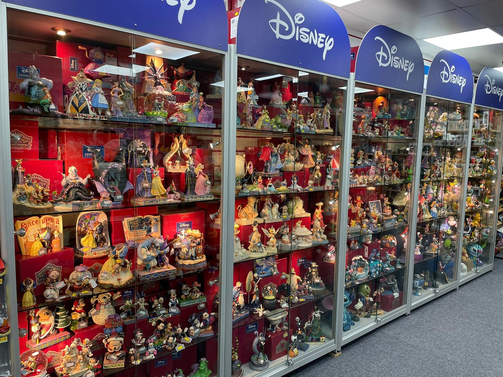 Display shelf featuring rare and limited edition Disney Traditions collectibles by Jim Shore