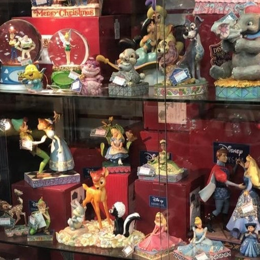 Top Disney collectible gift ideas for 2025 including Stitch plush, Belle figurine, and Warmies Mickey Mouse displayed in a festive gift setting