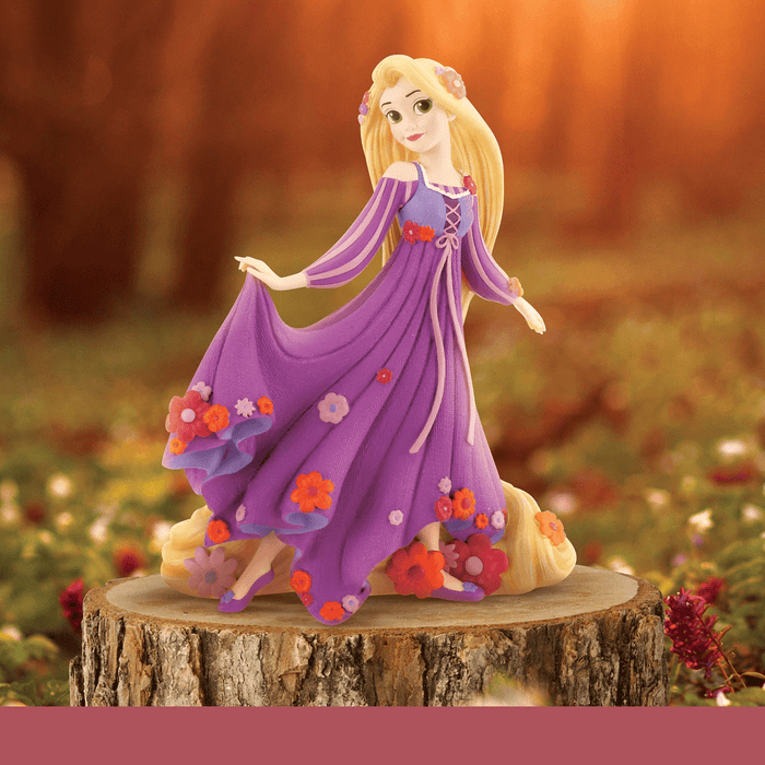 Disney Princess collectible figurines featuring Belle, Ariel, Rapunzel, and Cinderella in a display