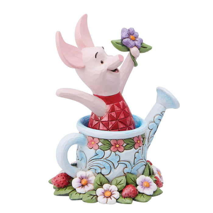Figurine de porcelet dans un arrosoir