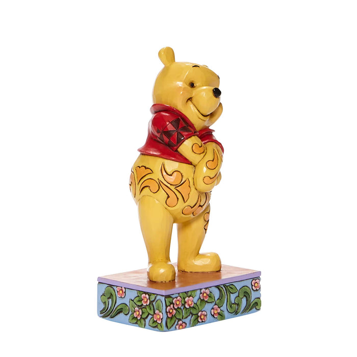 Side view of Beloved Bear – Winnie the Pooh Personality Pose Figurine – Enesco Disney Traditions by Jim Shore, featuring intricate folk-art details.