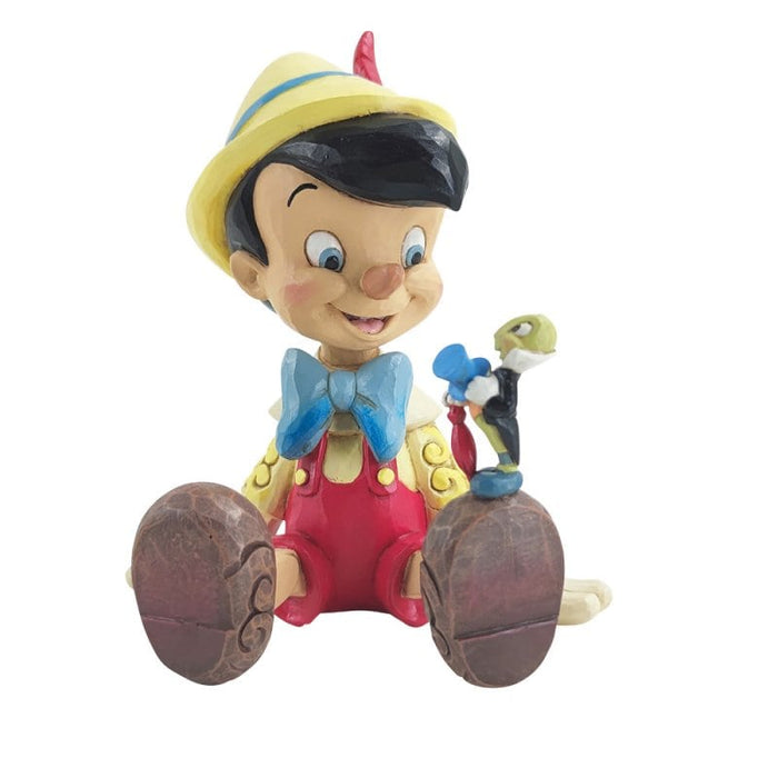Pinocchio and Jiminy Sitting Figurine – Enesco Disney Traditions by Jim Shore, hand-painted collectible featuring Pinocchio and Jiminy Cricket sitting together.