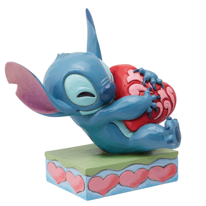 Side view of Stitch Hugging a Heart Figurine – Enesco Disney Traditions by Jim Shore, featuring folk-art details.