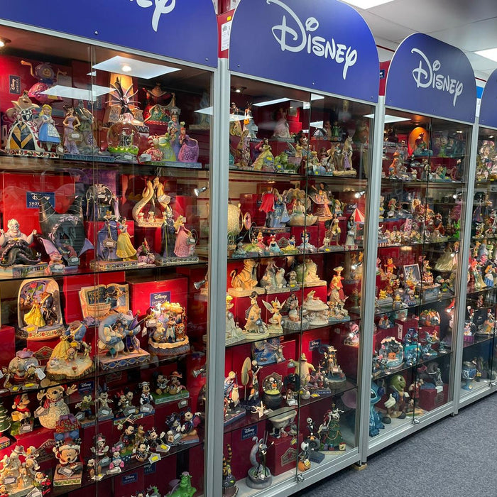 Display shelf featuring rare and limited edition Disney Traditions collectibles by Jim Shore